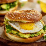 Avocado bagel breakfast sandwich with fried egg